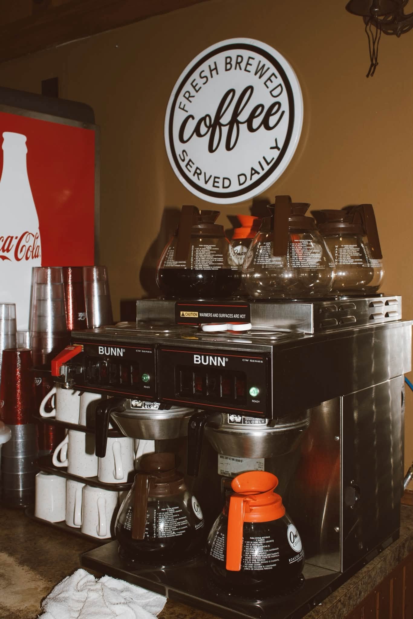 BUNN coffee station with "Fresh Brewed Coffee Served Daily" sign at The Kove