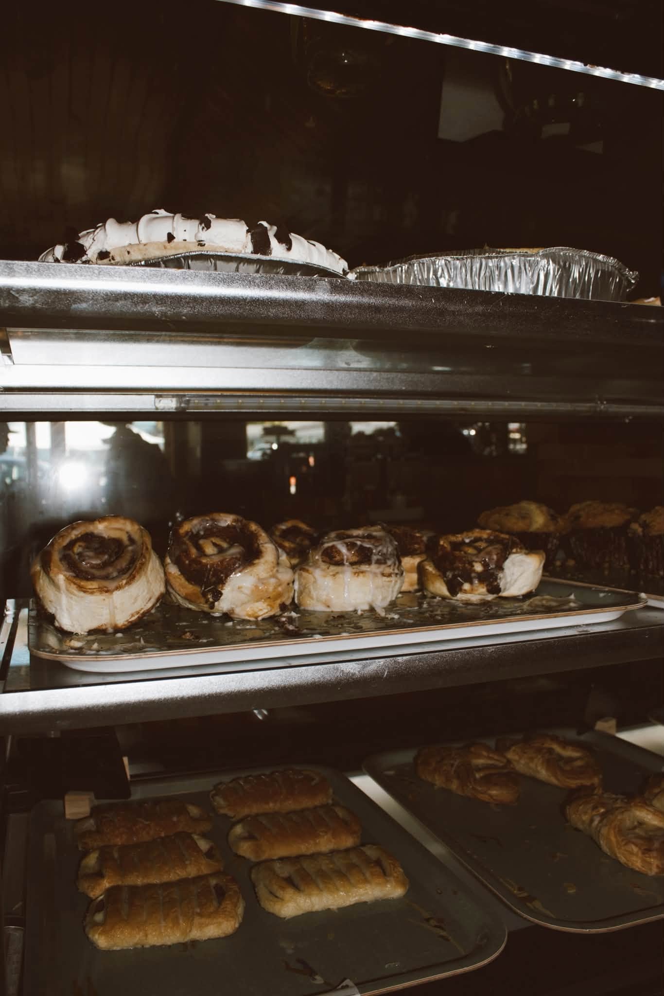 Cinnamon rolls, pastries, and pies in The Kove bakery case